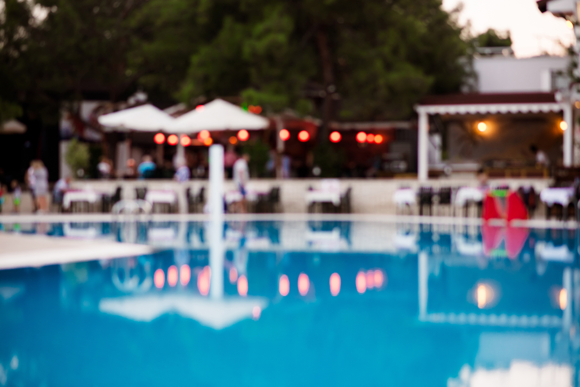 Blur summer background for resort hotel pool party with blue